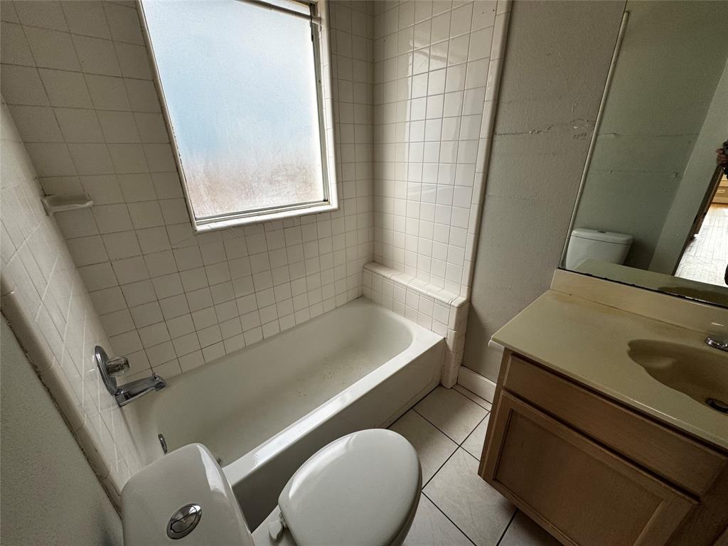 5321 Reiger Avenue, Unit 1 Dallas, TX 75214 - Photo 7 of 18 a bathroom with a sink and a mirror