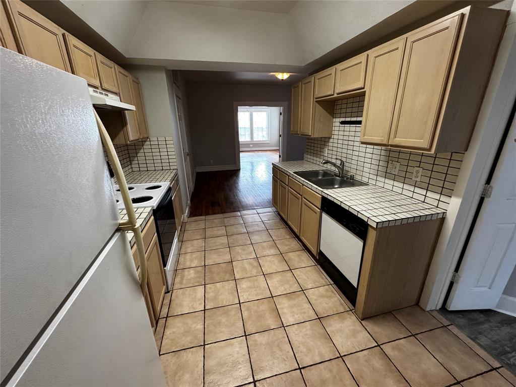 5321 Reiger Avenue, Unit 1 Dallas, TX 75214 - Photo 9 of 18 a kitchen with stainless steel appliances granite countertop a stove a sink and a refrigerator