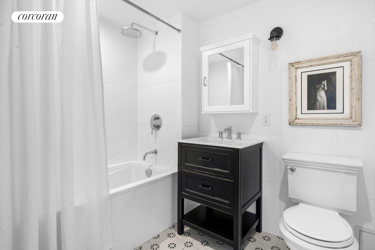 1255 Bushwick Avenue, Unit 5C Brooklyn, NY 11207 - Photo 5 of 8 a bathroom with a sink a toilet and shower