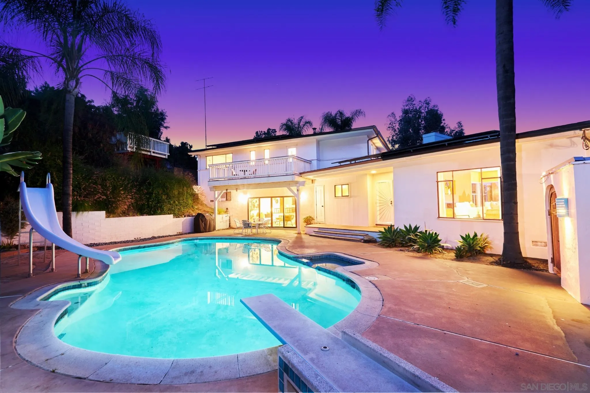 a view of a swimming pool with chairs