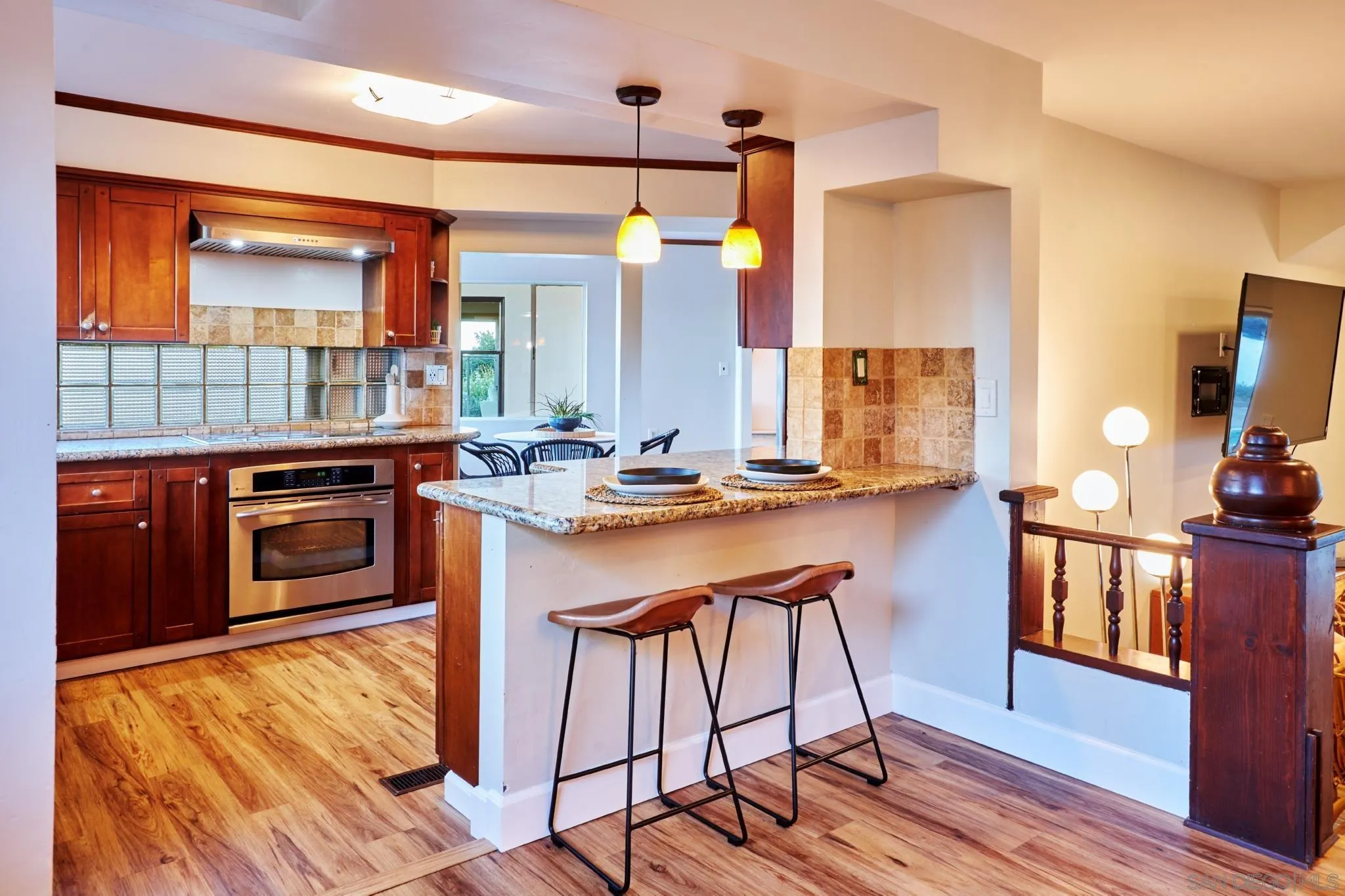 9080 Terrace Drive La Mesa, CA 91941 - Photo 12 of 25 a kitchen with stainless steel appliances a stove a sink dishwasher and a refrigerator with wooden floor