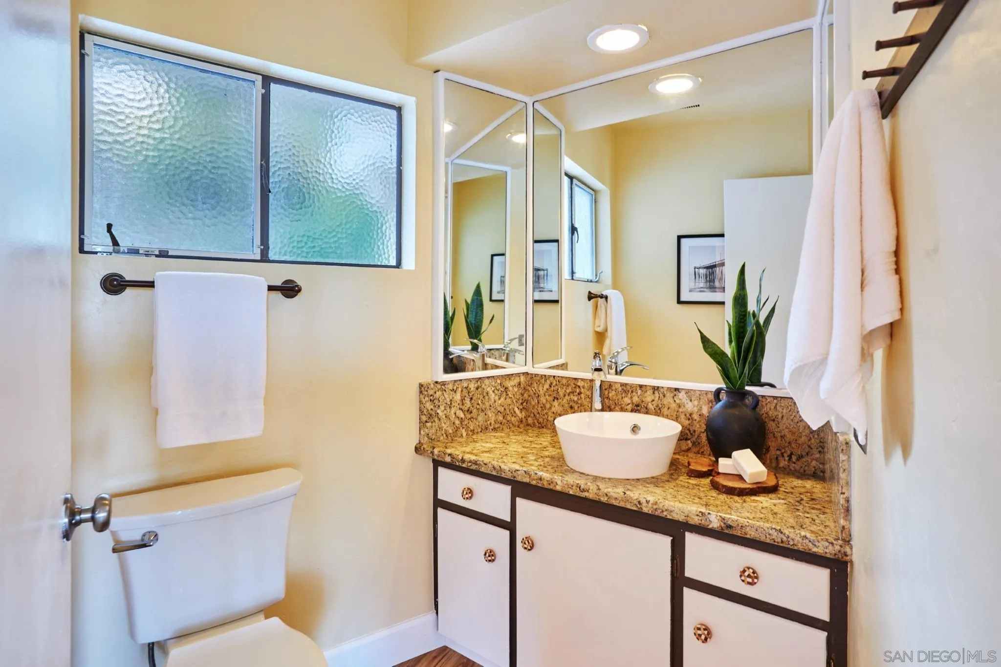 9080 Terrace Drive La Mesa, CA 91941 - Photo 16 of 25 a bathroom with a granite countertop sink and a mirror