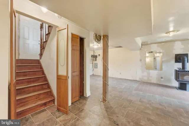a view of a hallway with wooden floor and entryway