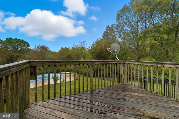 a view of balcony with wooden floor and fence