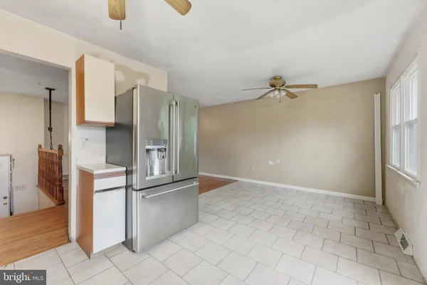 a view of a kitchen with a refrigerator and a sink