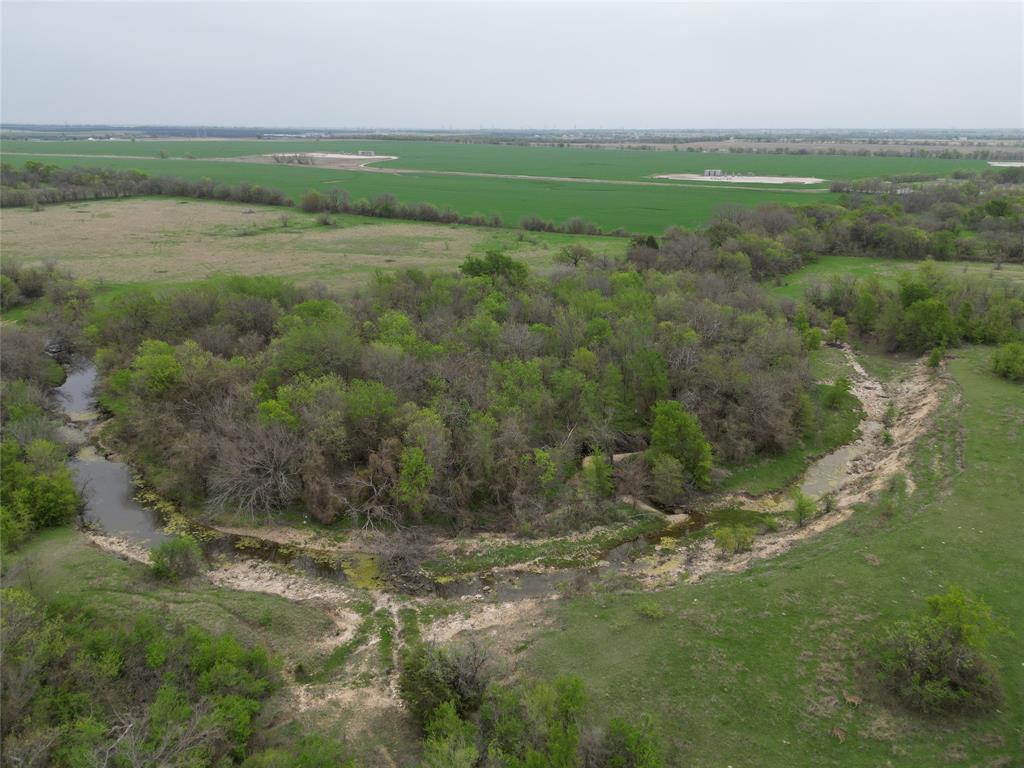 a view of a field with an trees