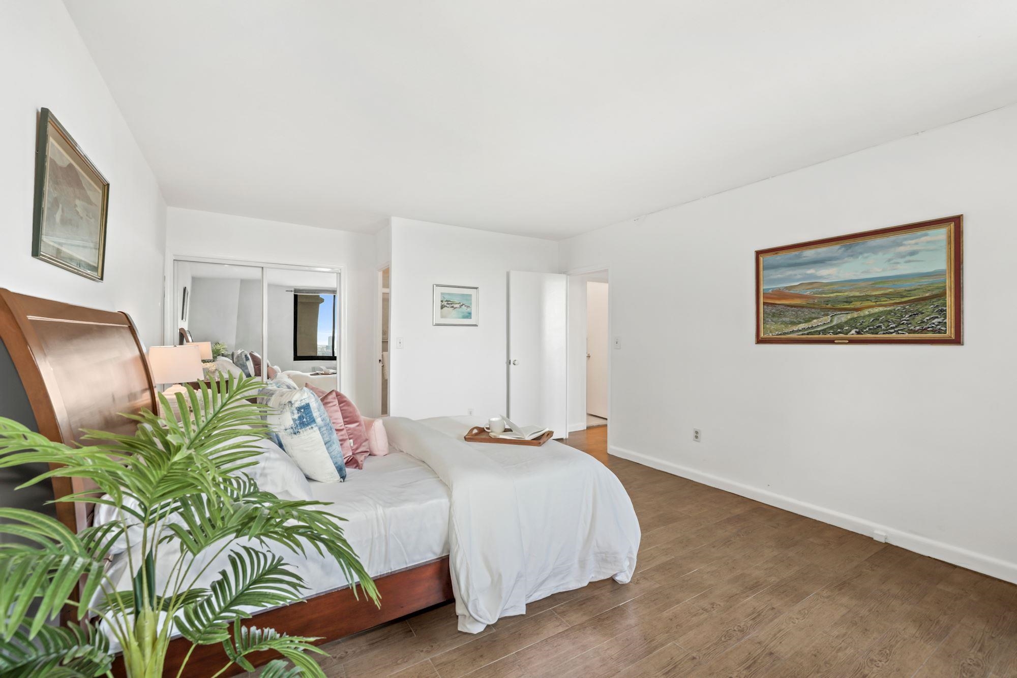 380 Mountain Road, Unit 704 Union City, NJ 07087 - Photo 15 of 21 a bedroom with a bed with painting on the wall and a large window