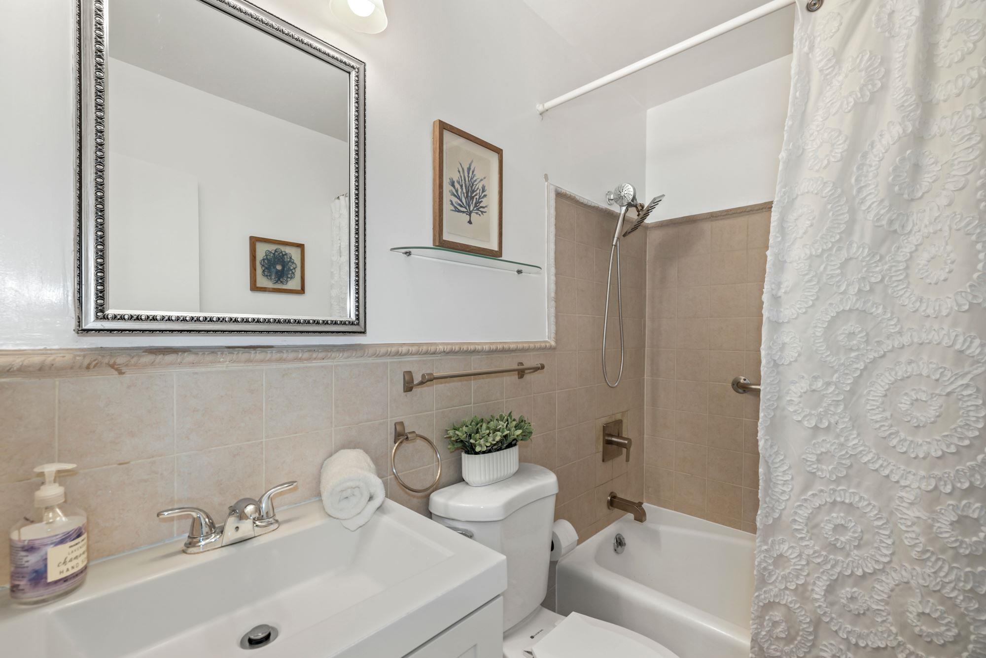 380 Mountain Road, Unit 704 Union City, NJ 07087 - Photo 17 of 21 a bathroom with a sink a toilet and shower