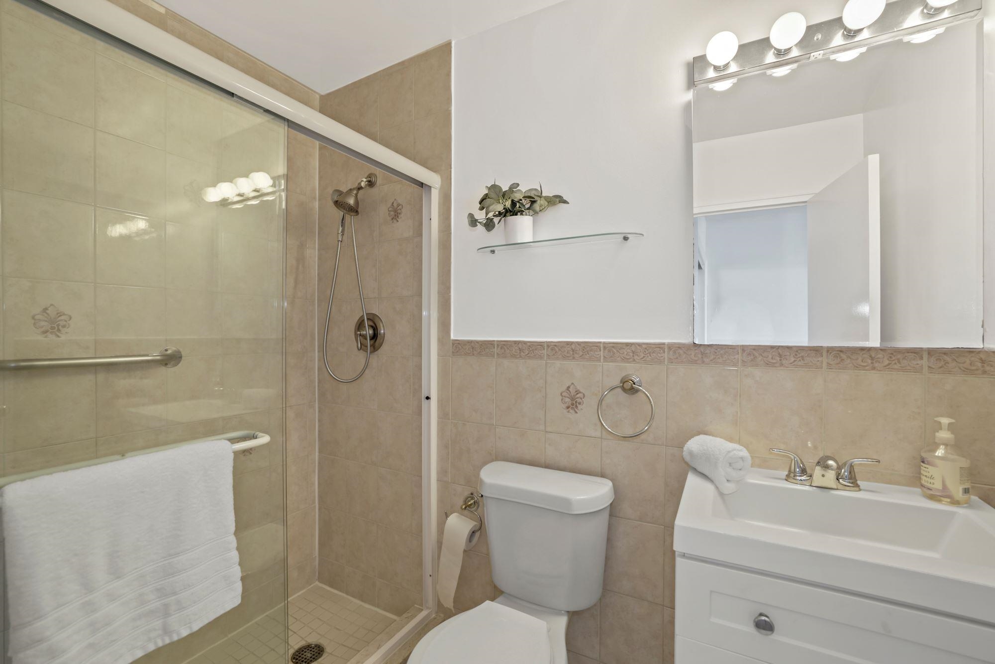 380 Mountain Road, Unit 704 Union City, NJ 07087 - Photo 18 of 21 a bathroom with a toilet sink shower and mirror
