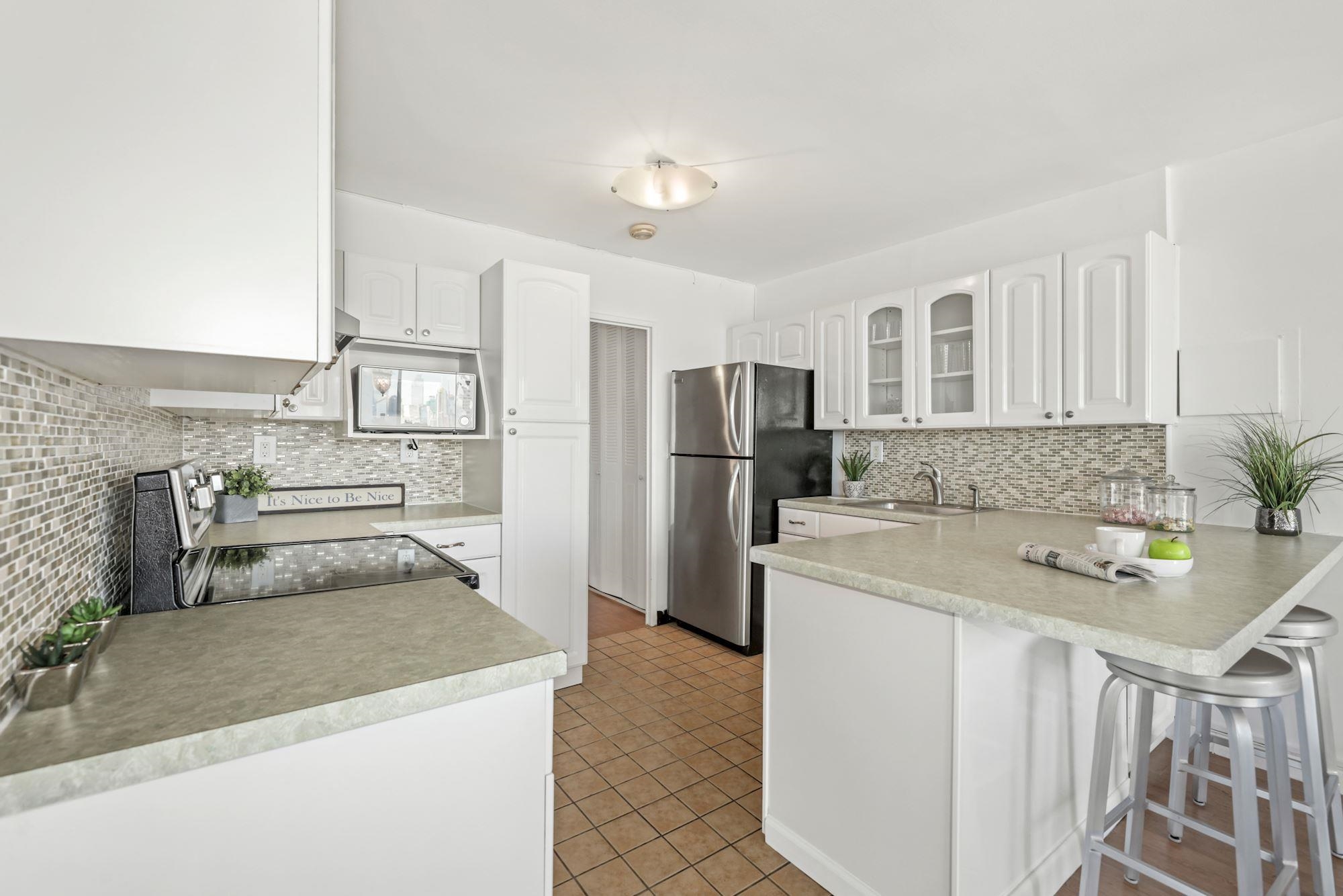 380 Mountain Road, Unit 704 Union City, NJ 07087 - Photo 4 of 21 a kitchen with stainless steel appliances granite countertop a sink stove and refrigerator