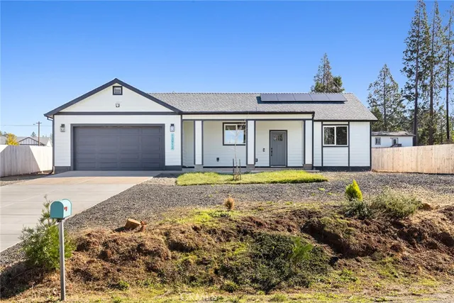 a view of pool with yard in front of it