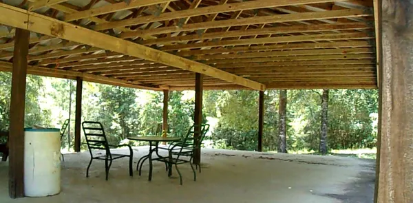 a patio with glass top table and chairs