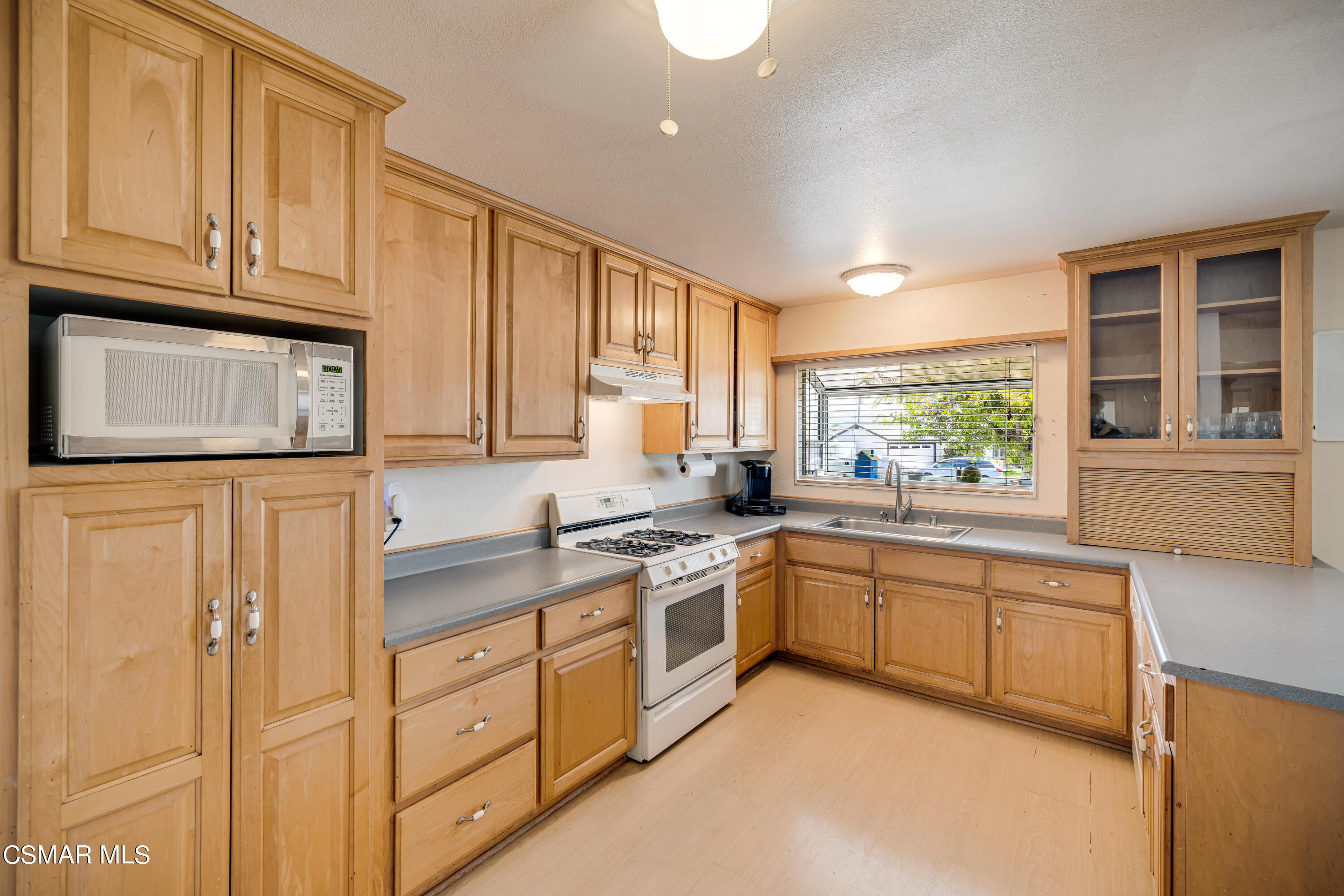 3379 Weatherford Court Simi Valley, CA 93063 - Photo 23 of 39 a kitchen with white cabinets and white appliances