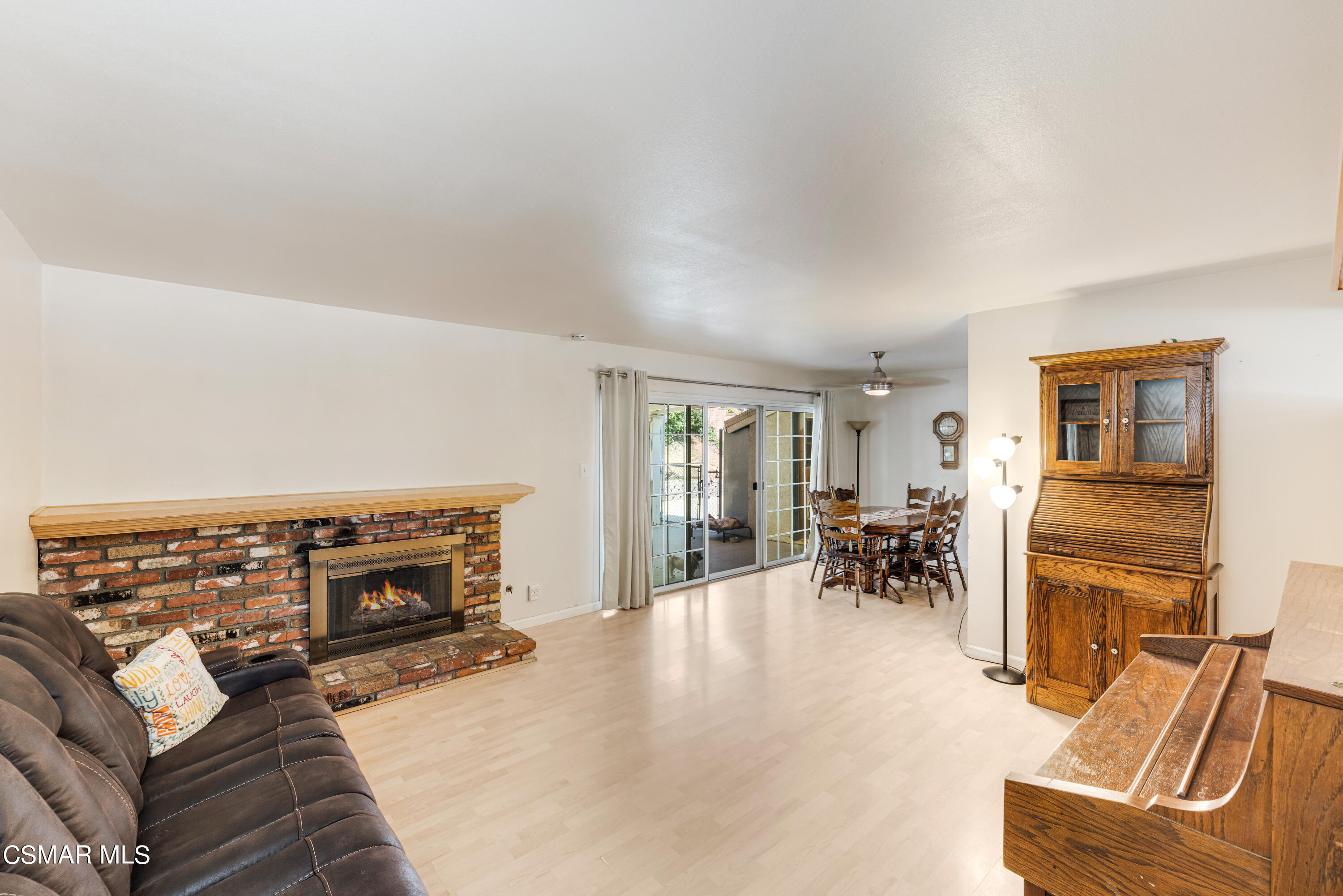 3379 Weatherford Court Simi Valley, CA 93063 - Photo 26 of 39 a living room with furniture and a dining table with fireplace