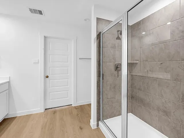 a bathroom that has a glass shower door