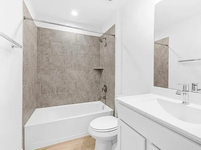 a bathroom with a sink a toilet and a bathtub