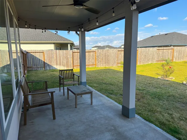 a view of a two chairs and table in the patio
