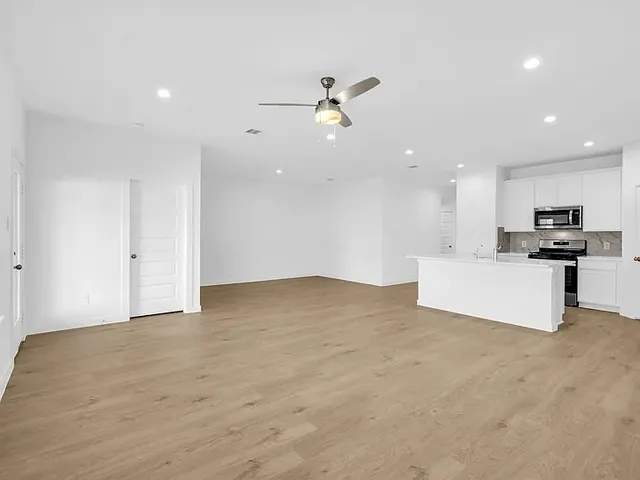 a view of a kitchen with a sink and cabinets
