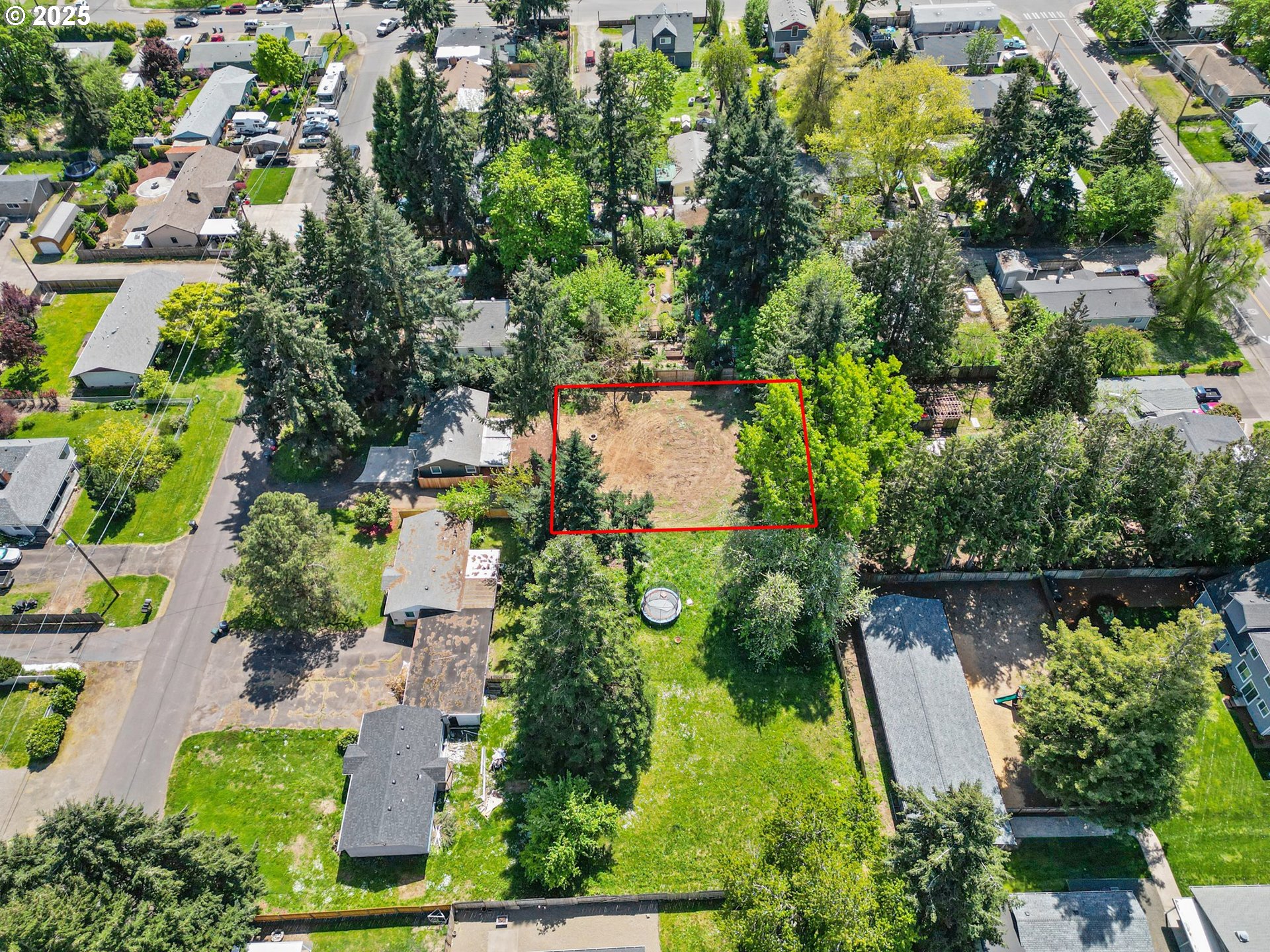 an aerial view of a house with a yard and lake view