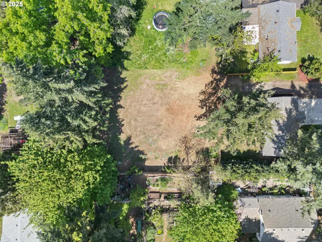 an aerial view of a residential houses with outdoor space