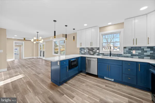a kitchen with stainless steel appliances granite countertop a stove a sink dishwasher and a refrigerator