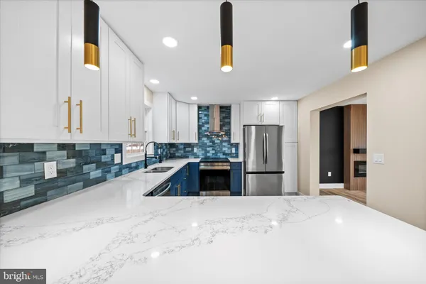 a large kitchen with kitchen island a sink stainless steel appliances and cabinets