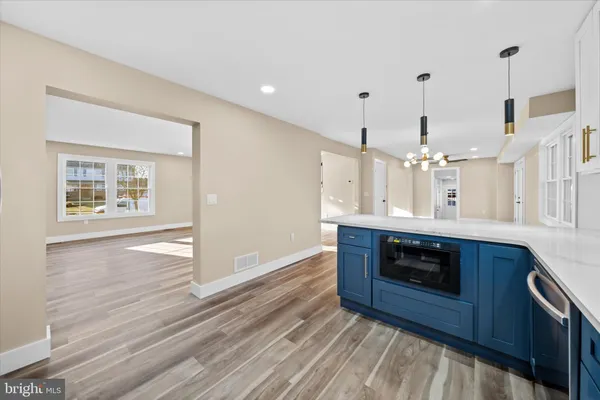 a kitchen with stainless steel appliances granite countertop a stove a sink and a wooden floors