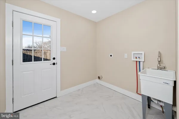 a view of hallway with sink and mirror