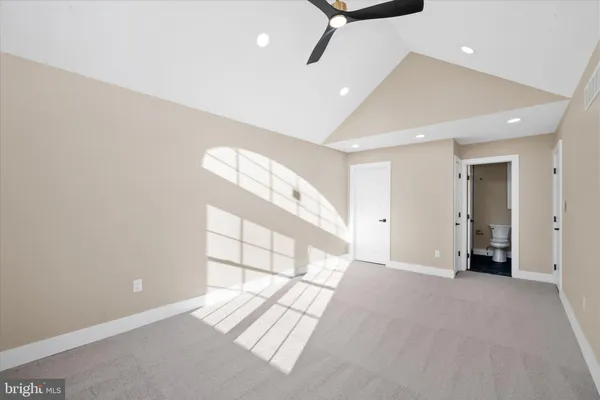 an empty room with windows and closet