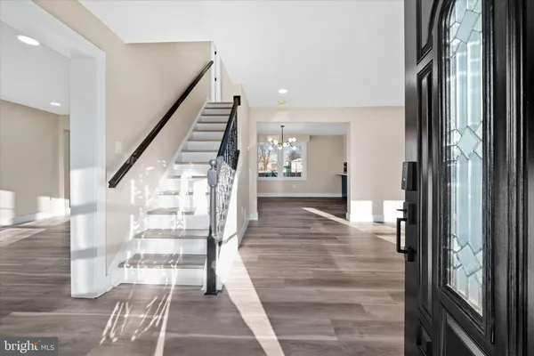 a view of entryway and hall with wooden floor