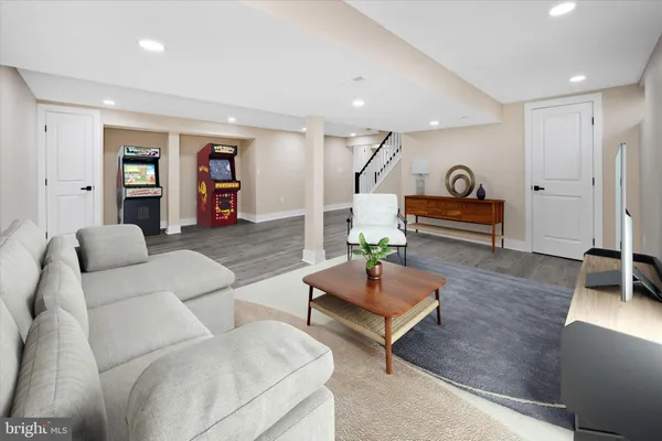 a living room with furniture and wooden floor