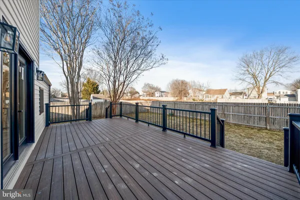 a view of outdoor space with deck and large trees