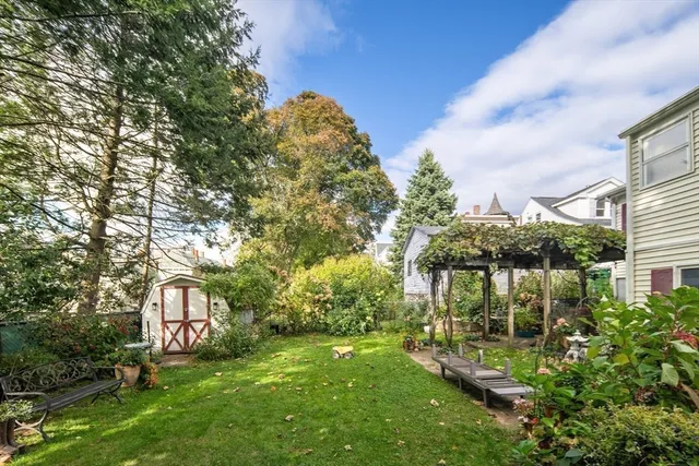 a front view of a house with a yard and garden