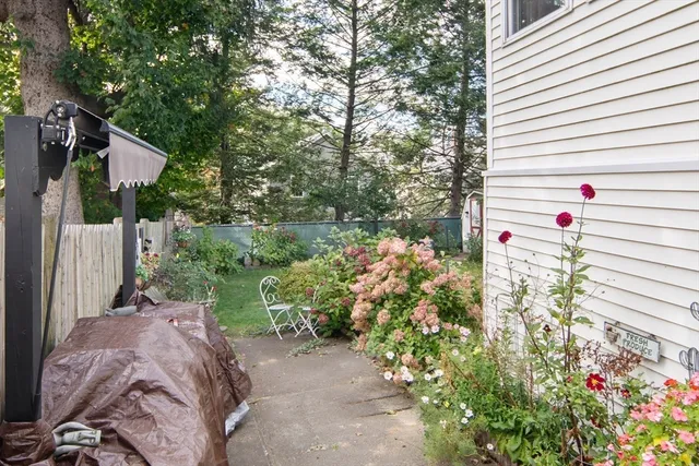 a view of a house with a small yard and wooden fence