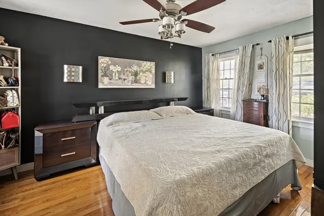 a bedroom with a large bed and a chandelier