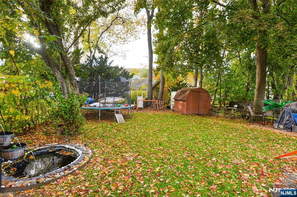110 3rd Avenue Hawthorne, NJ 07506 - Photo 17 of 17 a backyard of a house with table and chairs