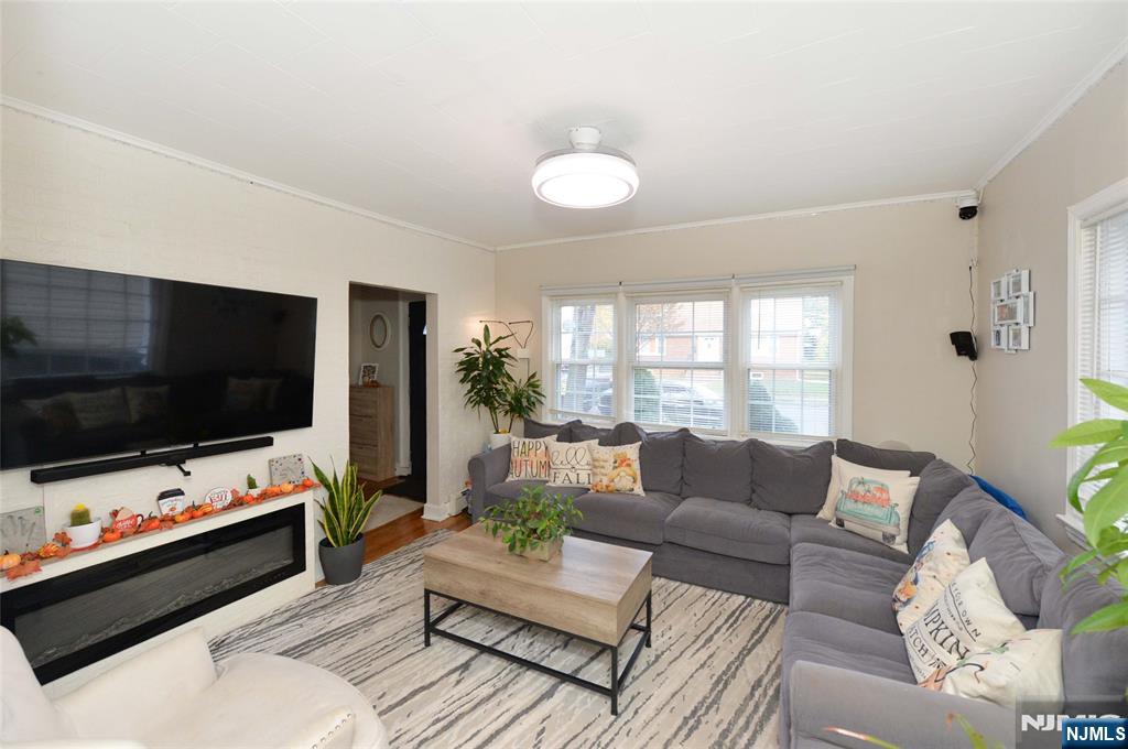 110 3rd Avenue Hawthorne, NJ 07506 - Photo 3 of 17 a living room with furniture and a flat screen tv
