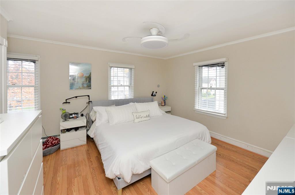 110 3rd Avenue Hawthorne, NJ 07506 - Photo 8 of 17 a spacious bedroom with a bed and a large window
