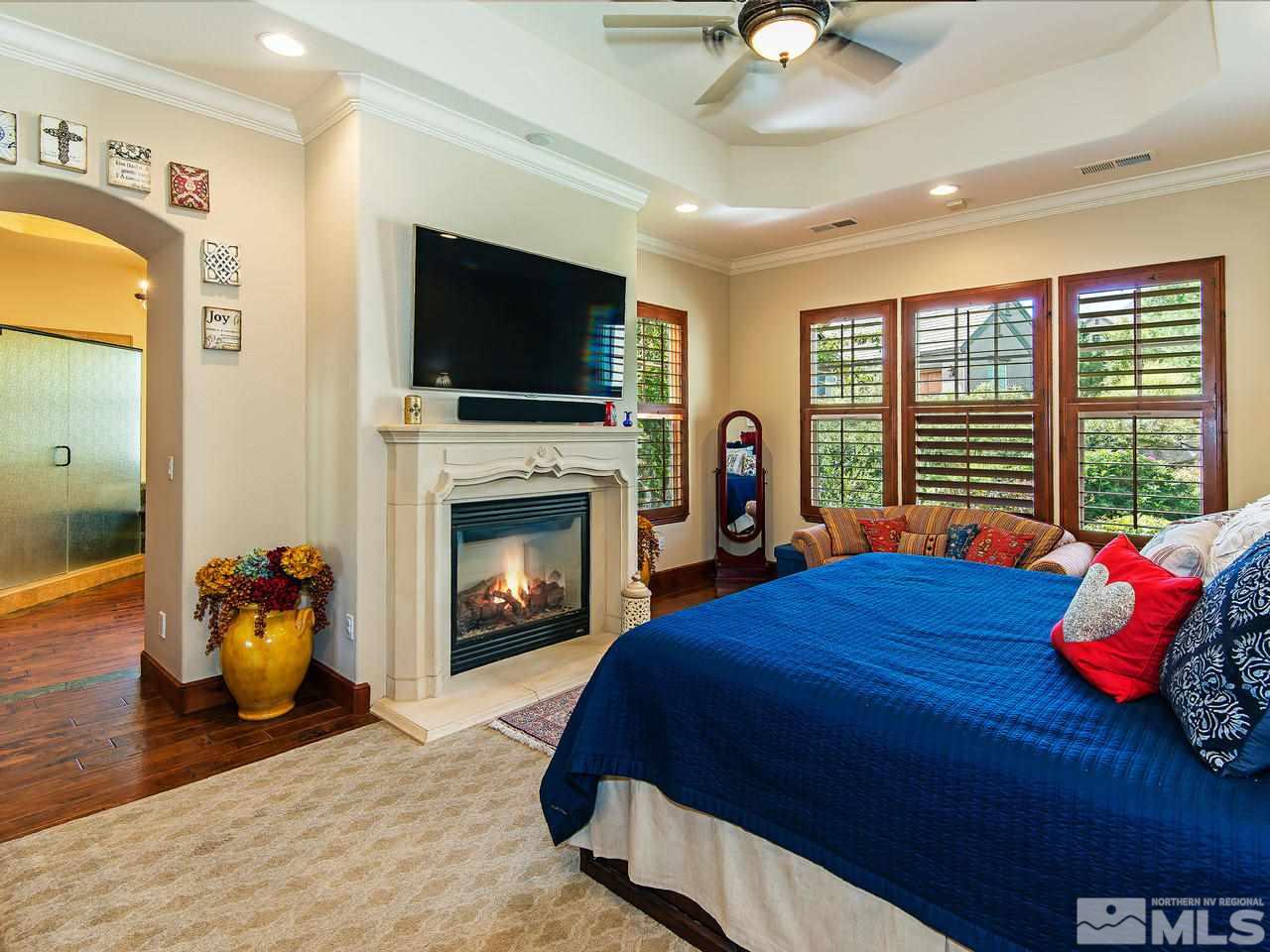 16885 Delacroix Reno, NV 89511 - Photo 15 of 25 a bedroom with a bed and a fireplace