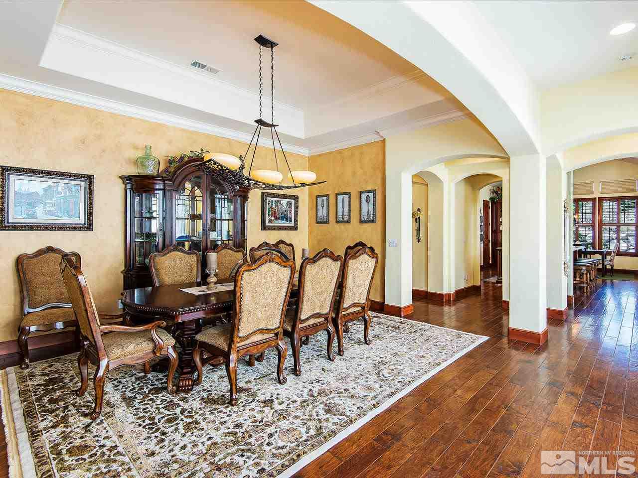 16885 Delacroix Reno, NV 89511 - Photo 7 of 25 a dining room with furniture a chandelier and wooden floor