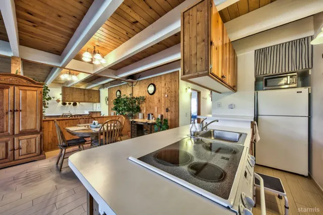 a kitchen with stainless steel appliances granite countertop a sink and a refrigerator