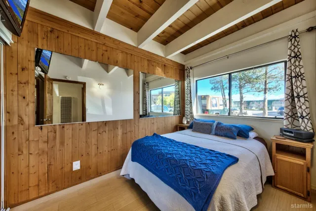 a bed sitting in a bedroom next to a window