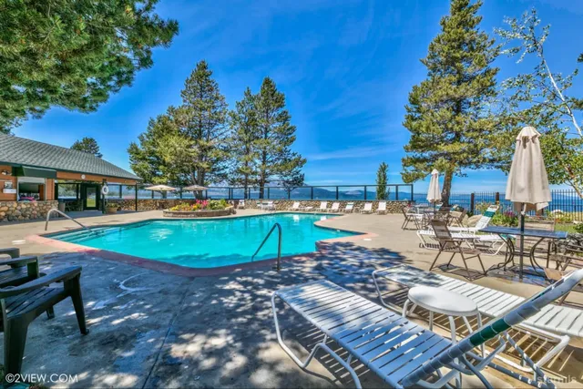 a swimming pool with outdoor seating and yard