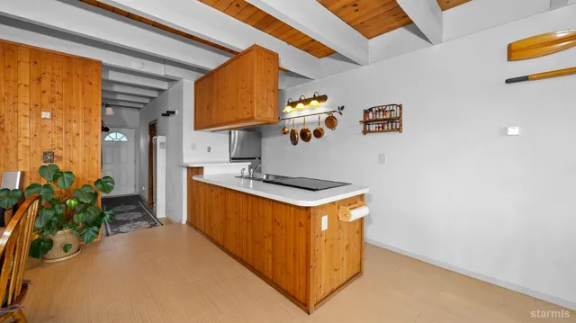 a kitchen with stainless steel appliances granite countertop a sink a stove and a refrigerator