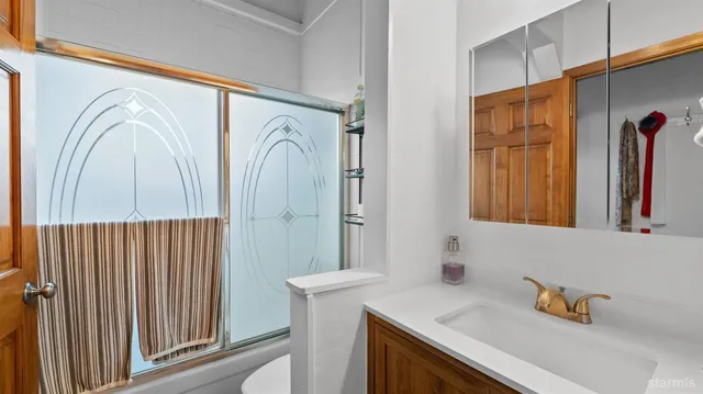 a bathroom with a sink a mirror and a window