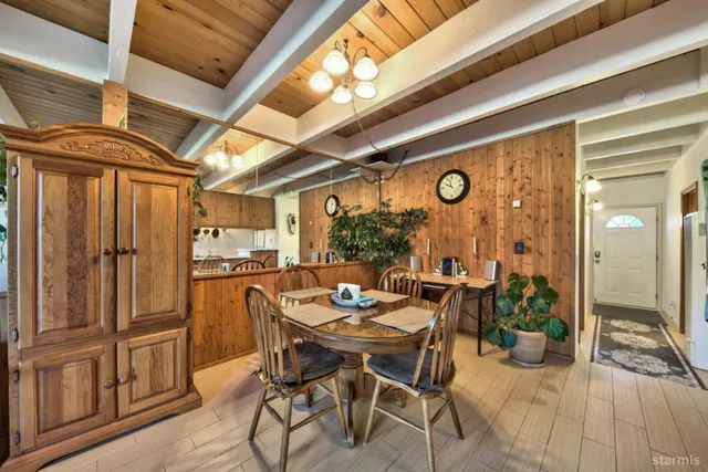 a dining room with furniture and a floor to ceiling window