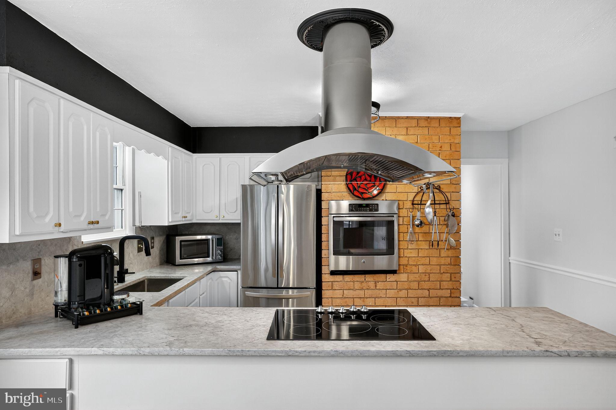 1716 Gayfields Drive Silver Spring, MD 20906 - Photo 18 of 55 a kitchen with stainless steel appliances granite countertop a sink and a stove