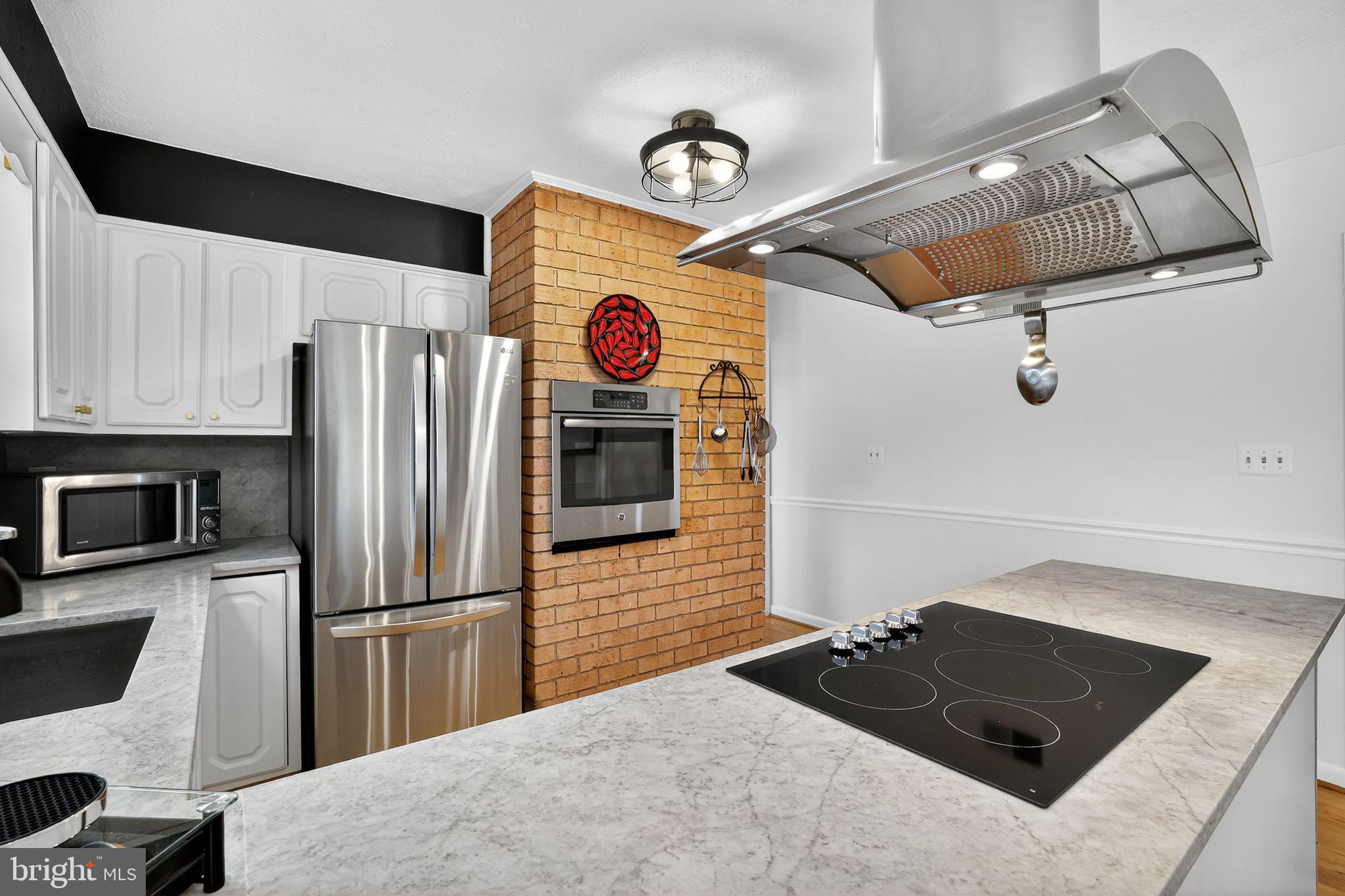 1716 Gayfields Drive Silver Spring, MD 20906 - Photo 19 of 55 a kitchen with a refrigerator and a stove top oven