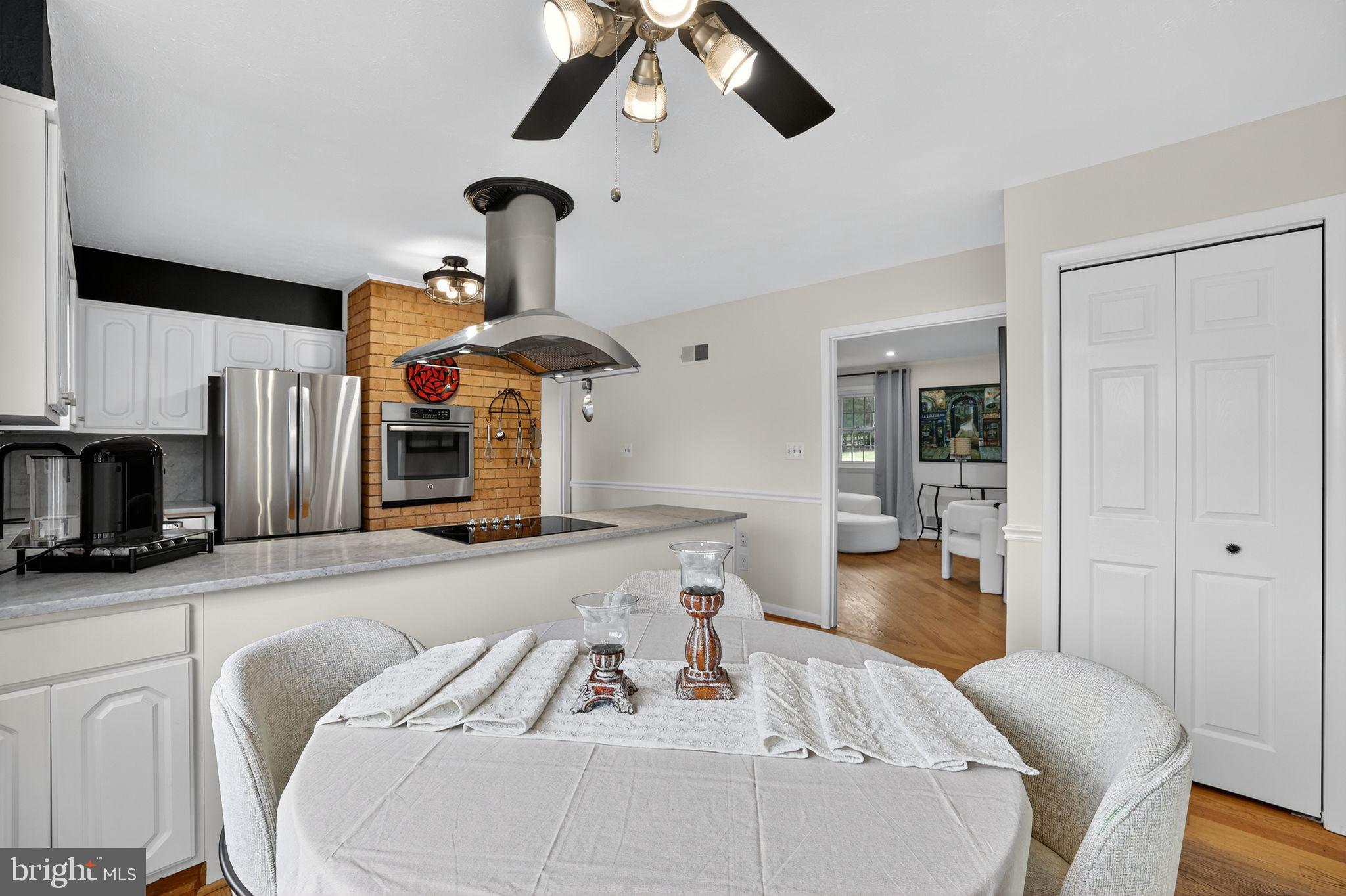 1716 Gayfields Drive Silver Spring, MD 20906 - Photo 23 of 55 a living room with stainless steel appliances furniture a fireplace and a flat screen tv