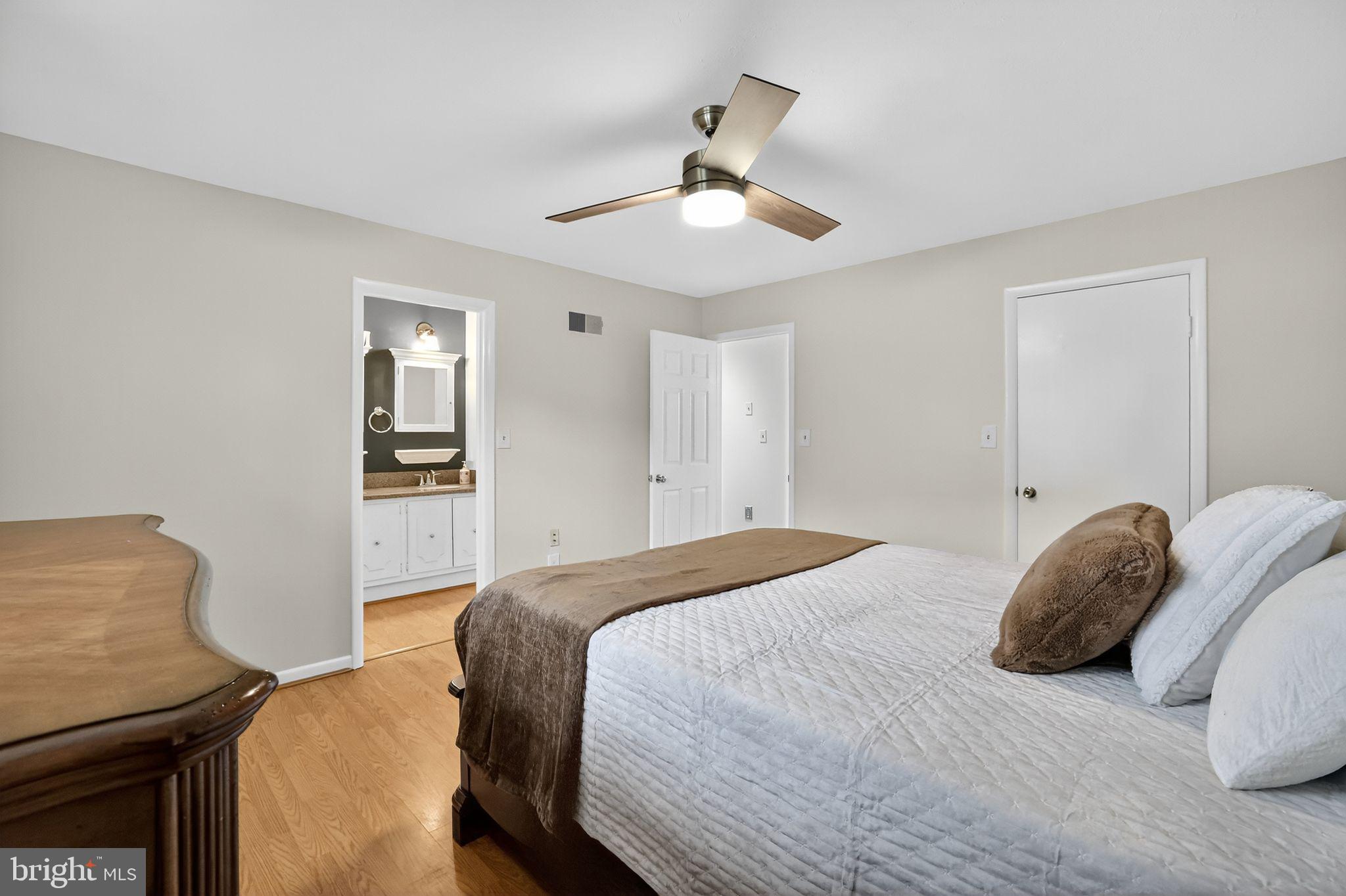 1716 Gayfields Drive Silver Spring, MD 20906 - Photo 30 of 55 a bedroom with a bed and a chandelier
